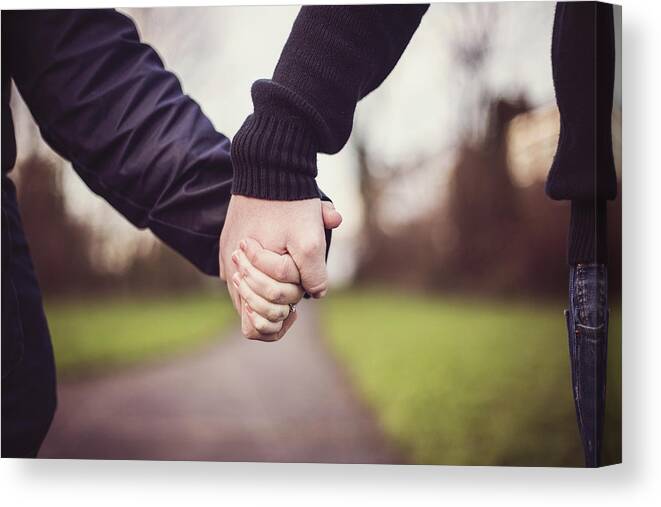 Heterosexual Couple Canvas Print featuring the photograph Couple holding hands by Sally Anscombe