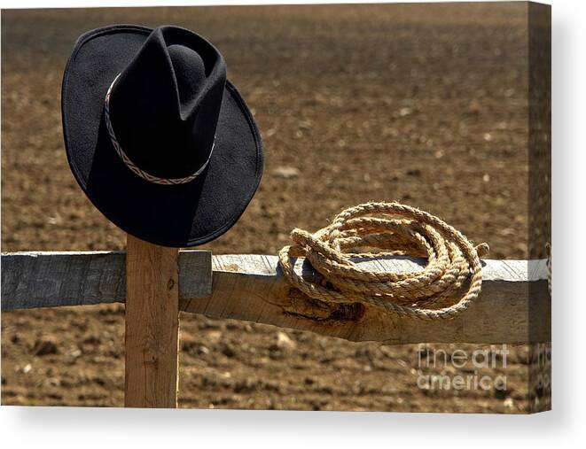Western Canvas Print featuring the photograph Cowboy Hat and Rope on Fence by Olivier Le Queinec