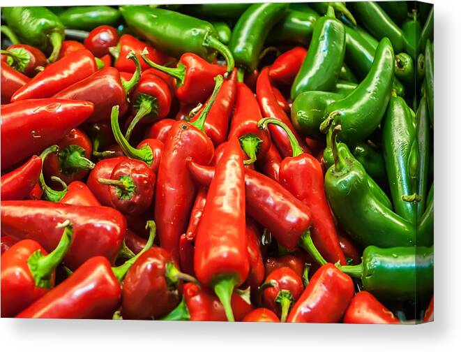 Bunch Canvas Print featuring the photograph Delicious fresh green and red chili fruit on display at supermar by Alex Grichenko