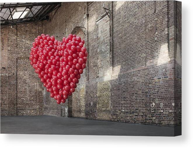 Mid-air Canvas Print featuring the photograph Empty warehouse with red heart made of balloons by Anthony Harvie