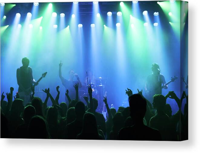 Young Men Canvas Print featuring the photograph Enjoying Every Song The Band Plays by Yuri arcurs