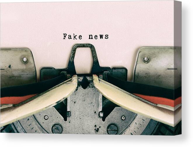 Event Canvas Print featuring the photograph Fake News type on Vintage Typewriter by Nora Carol Photography