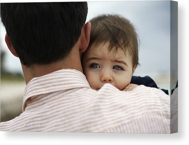 Young Men Canvas Print featuring the photograph Father carrying baby daughter (15-18 months) outdoors, close-up by Erik Snyder