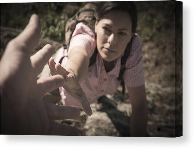 Human Arm Canvas Print featuring the photograph Female Rock Climber Reaching for Helping Hand by Mats Silvan