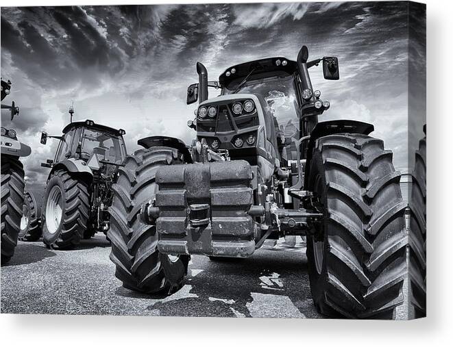 Tractor Canvas Print featuring the photograph Giant Tractors Against Stormy Sky by Christian Lagereek