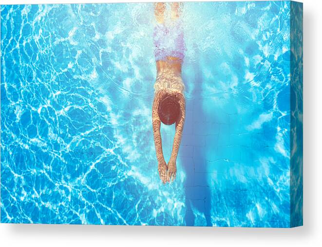 Underwater Canvas Print featuring the photograph Happy boy diving in the swimming pool by Da-kuk