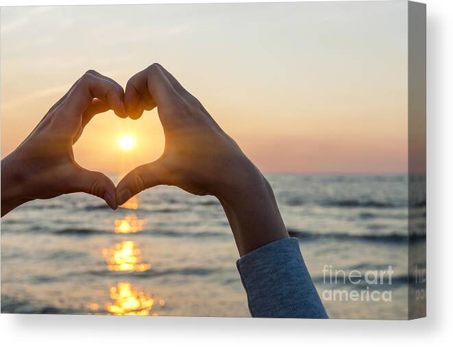 Heart Canvas Print featuring the photograph Heart shaped hands framing ocean sunset by Elena Elisseeva