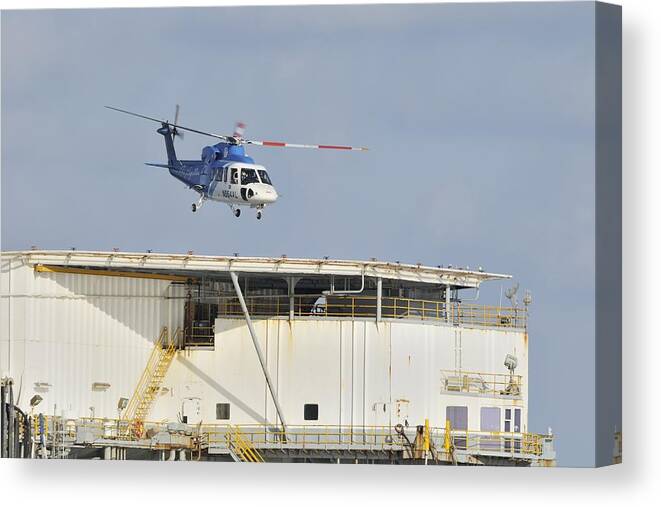 Helicopter Canvas Print featuring the photograph Helicopter landing on oil rig by Bradford Martin