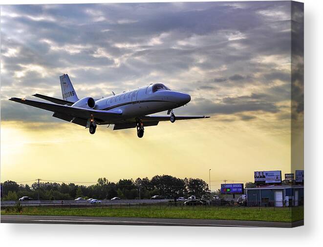 Airplane Canvas Print featuring the photograph Landing at Sunrise by Jason Politte