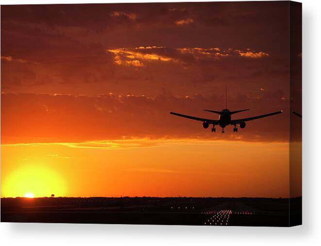 Plane Canvas Print featuring the photograph Landing into the Sunset by Andrew Soundarajan