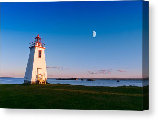 Beautiful Canvas Print featuring the photograph Lighthouse in the light from moon and sun by U Schade
