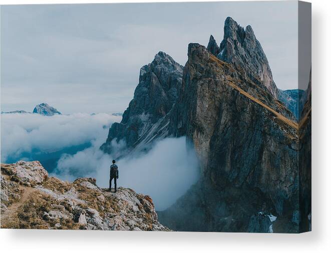 Tranquility Canvas Print featuring the photograph Man hiking near Seceda mountain in Dolomites by Oleh_Slobodeniuk