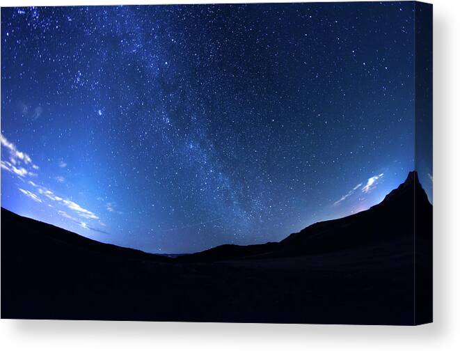 Scenics Canvas Print featuring the photograph Milky Way Galaxy In The Night Sky by Harpazo hope