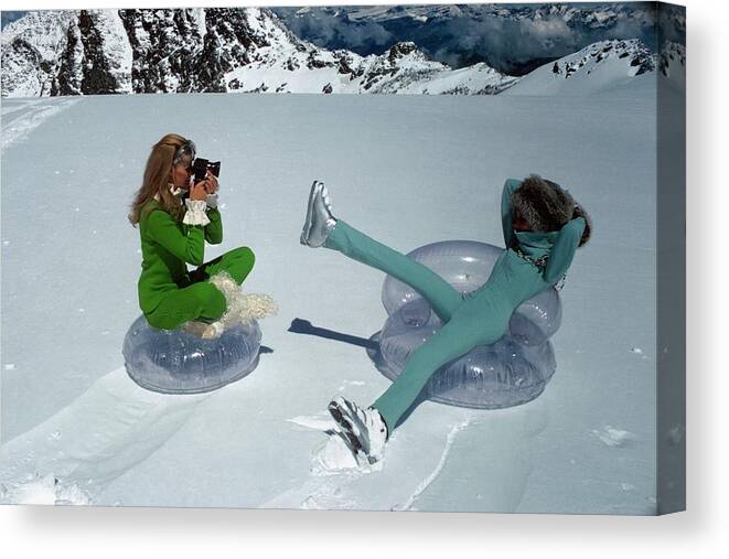 Fashion Canvas Print featuring the photograph Models On Plastic Chairs With Snow In Switzerland by Arnaud de Rosnay