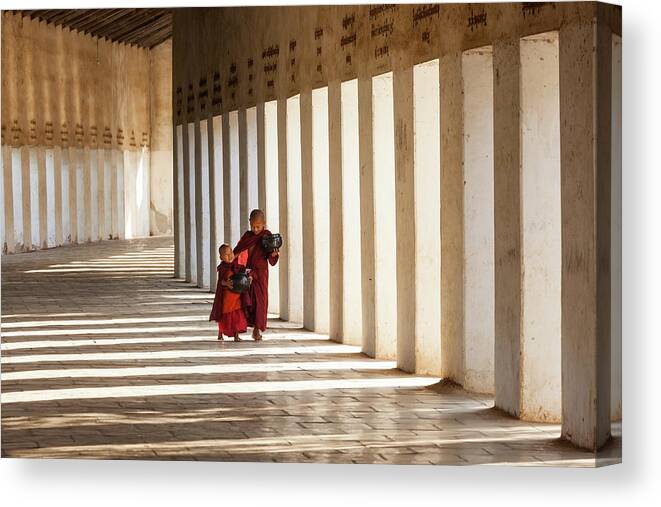 Asian And Indian Ethnicities Canvas Print featuring the photograph Monks In Walkway To Shwezigon Pagoda by Peter Adams