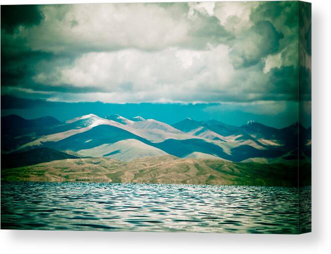 Mountains Canvas Print featuring the photograph Mountain lake in tibet Manasarovar by Raimond Klavins