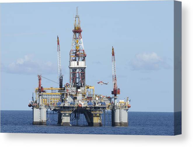 Oil Rig Canvas Print featuring the photograph Oil rig and helicopter by Bradford Martin