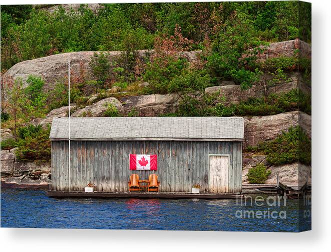 Boathouse Canvas Print featuring the photograph Old boathouse with two Muskoka chairs by Les Palenik