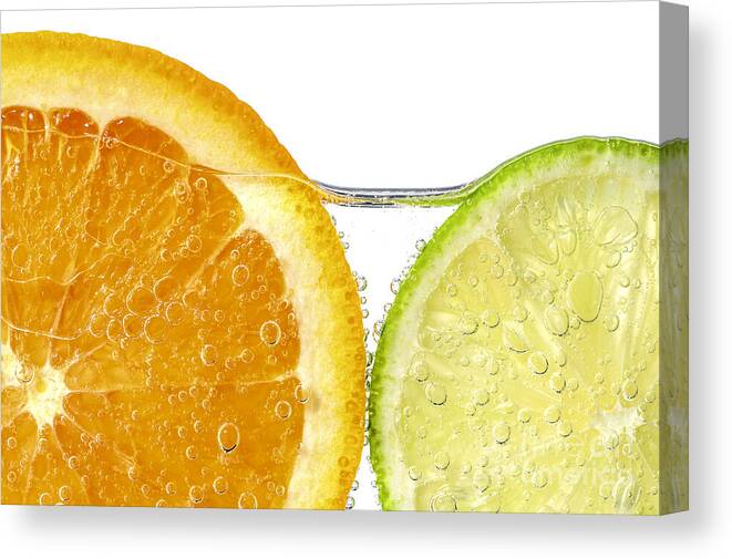 Orange Canvas Print featuring the photograph Orange and lime slices in water by Elena Elisseeva