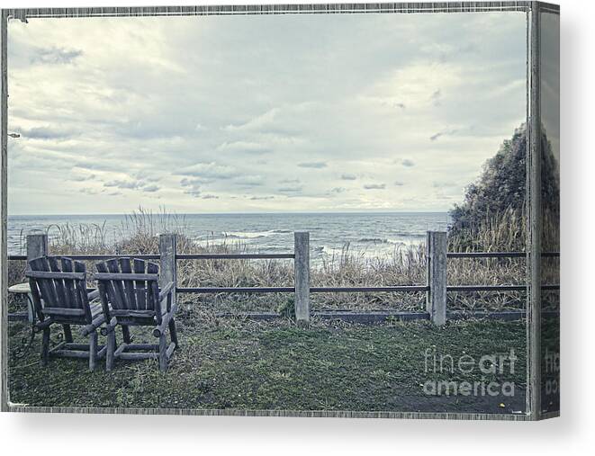 Wooden Chairs Canvas Print featuring the photograph Pair of Wooden Chairs Overlooking Ocean on a Cold Grey Afternoon by Beverly Claire Kaiya
