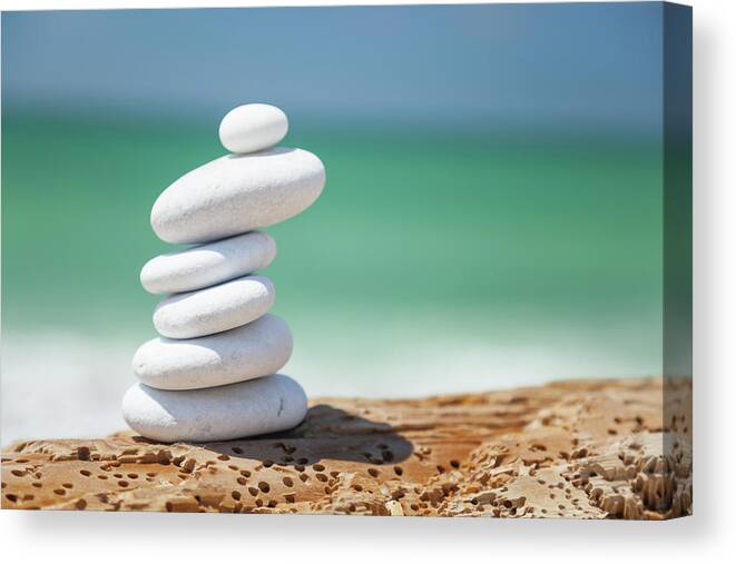 Toughness Canvas Print featuring the photograph Pebbles At The Beach by Focusstock