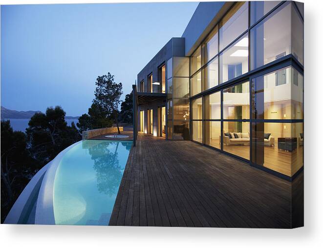 Swimming Pool Canvas Print featuring the photograph Pool outside modern house at twilight by Martin Barraud