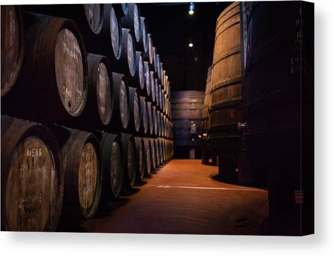 Alcohol Canvas Print featuring the photograph Port wine barrels in warehouse of Calem distillery in Porto by Maksim Ozerov