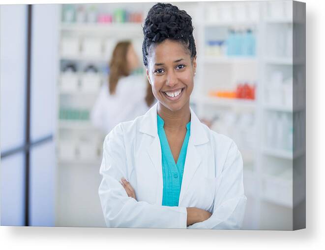 Working Canvas Print featuring the photograph Portrait of beautiful female pharmacist by Steve Debenport