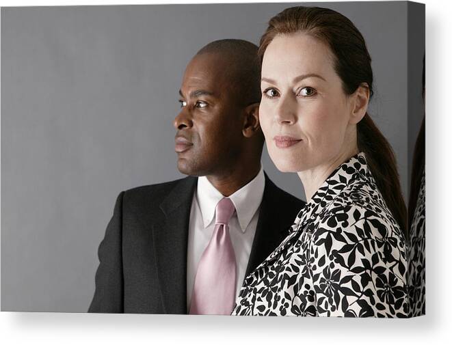 Heterosexual Couple Canvas Print featuring the photograph Portrait of businesspeople by Comstock Images