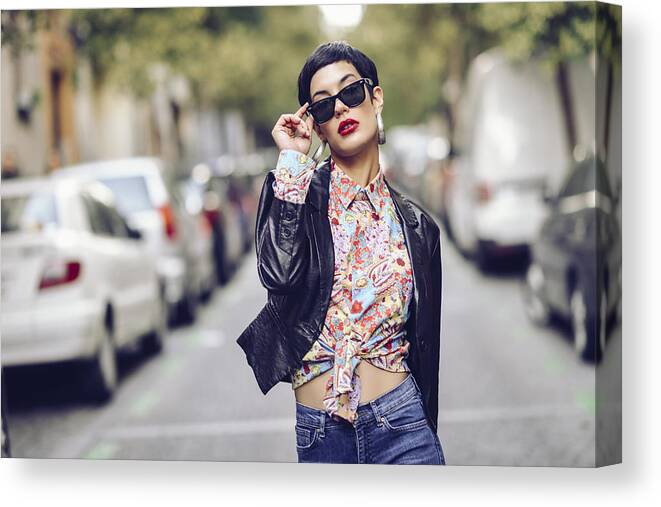 Cool Attitude Canvas Print featuring the photograph Portrait of fashionable young woman wearing sunglasses and leather jacket by Westend61