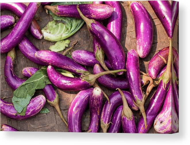 Purple Canvas Print featuring the photograph Purple Eggplants In Bamboo Basket by Merten Snijders