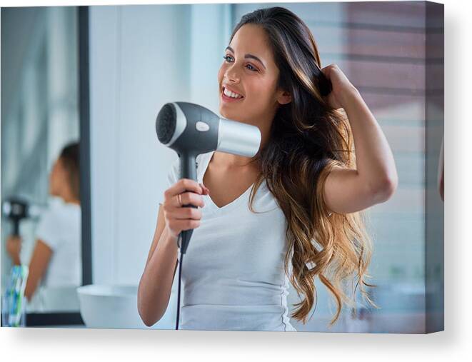 People Canvas Print featuring the photograph Putting great care into her hair by PeopleImages