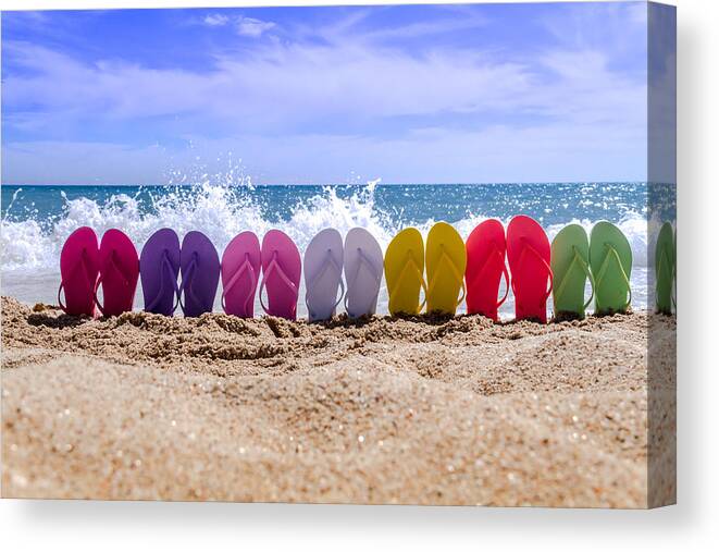 Water Canvas Print featuring the photograph Rainbow of Flip Flops on the Beach by Teri Virbickis