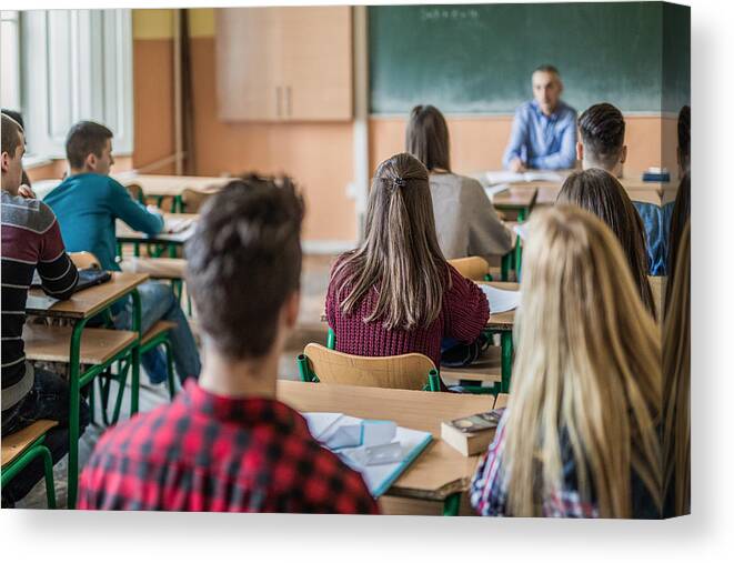 Education Canvas Print featuring the photograph Rear view of high school students attending a class. by Skynesher