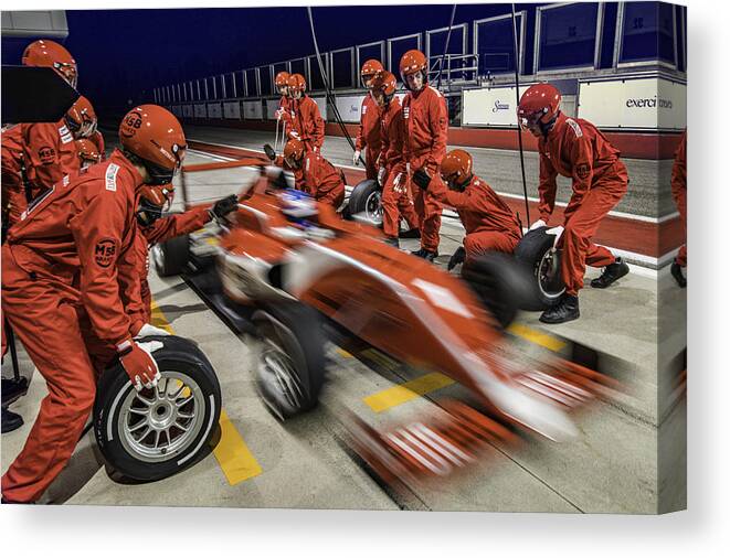 Crash Helmet Canvas Print featuring the photograph Red formula race car leaving the pit stop by Vm