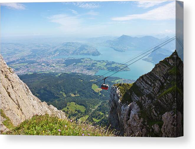 Extreme Terrain Canvas Print featuring the photograph Red Overhead Cable Car In Swiss Alps by Stockwerk
