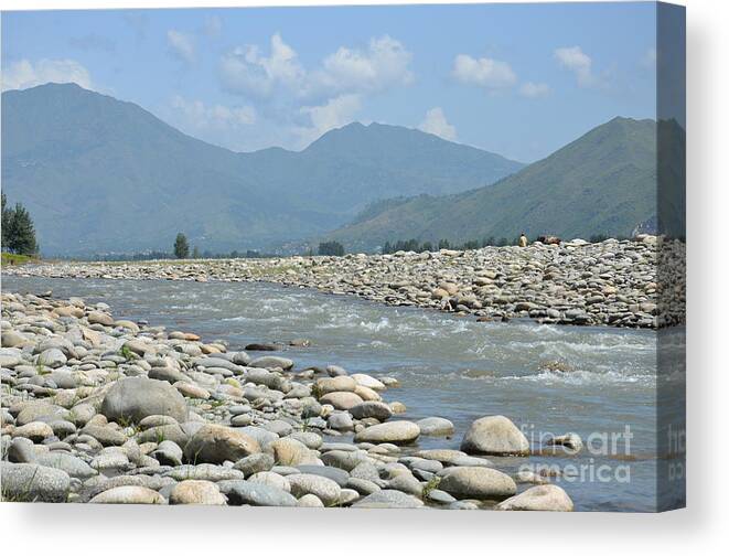 Landscape Canvas Print featuring the photograph Riverbank water rocks mountains and a horseman Swat Valley Pakistan by Imran Ahmed