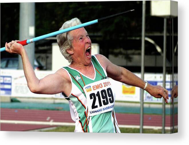 One Person Canvas Print featuring the photograph Senior Female Athlete Throws Javelin by Alex Rotas