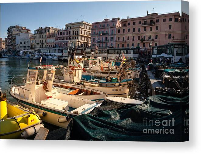 Anzio Canvas Print featuring the photograph small working fishing boats moored stern first in Anzio harbour by Peter Noyce