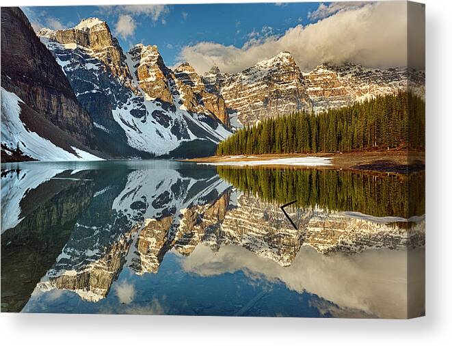 Scenics Canvas Print featuring the photograph Snow Clings To Shoreline Of Mountain by Ascentxmedia