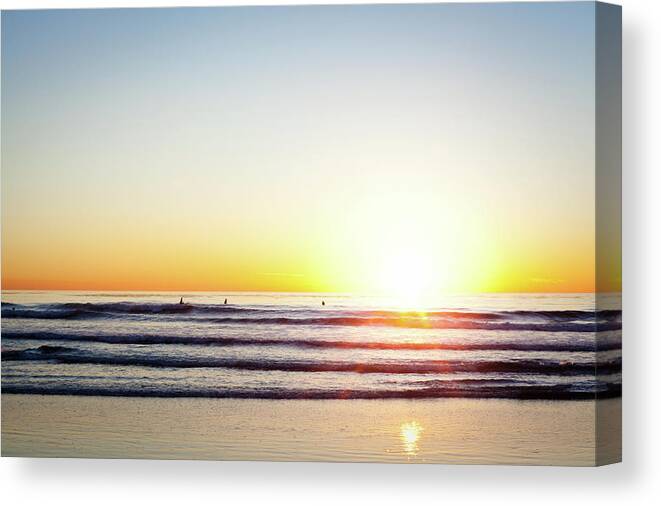 Orange Color Canvas Print featuring the photograph Sunset Surfers by Ianmcdonnell