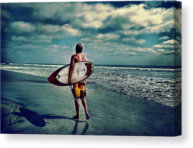 � Jamesdavidphotography; Photo; Photograph; Horizontal; Surf; Surfing; Surf Board; Board; Plank; Short; Long; Sport; Wet; Ocean; Pacific; Male; Teen; Wave; Breaker; Shore; Dscf3490; Lucisart; Fuji S5 Pro; Sand; Wave; Cloudly; Dramatic Canvas Print featuring the photograph Surfer walking the beach by James David Phenicie