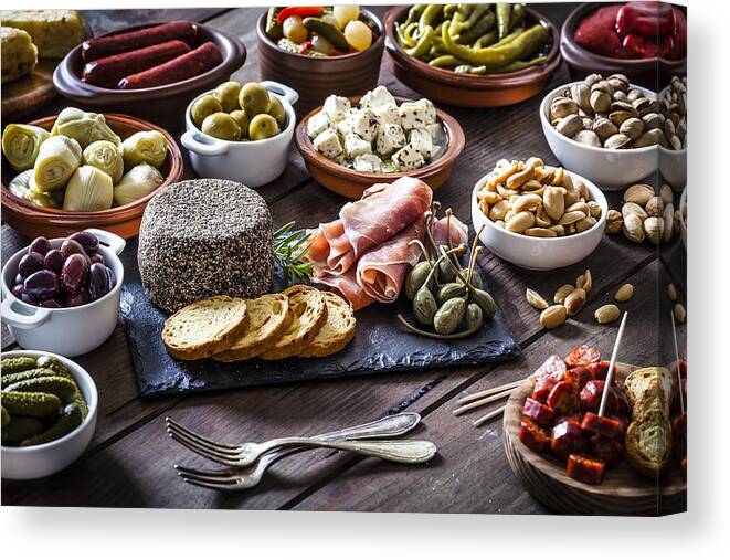 Tapenade Canvas Print featuring the photograph Tapas on rustic wooden table by Fcafotodigital