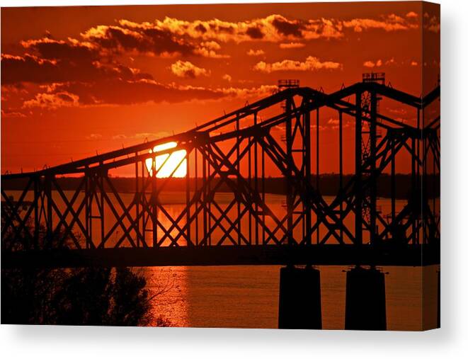 Mississippi River Canvas Print featuring the photograph The Mississippi River Bridge at Natchez at sunset. by Jim Albritton