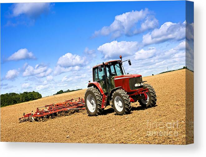 Tractor Canvas Print featuring the photograph Tractor in plowed farm field by Elena Elisseeva