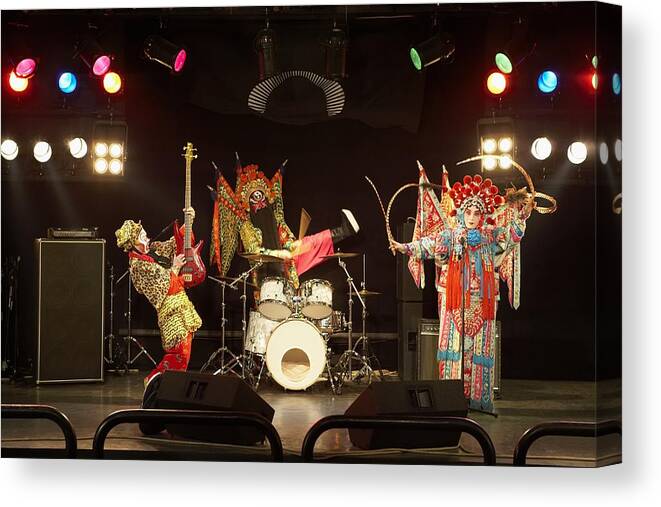 People Canvas Print featuring the photograph Two actors and an actress dressed as traditional Beijing Opera characters play rock and roll together on stage. by Blue Jean Images