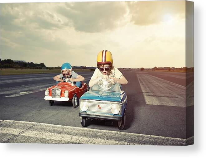 Cool Attitude Canvas Print featuring the photograph Two boys in pedal cars crossing finishing line on race track by Westend61