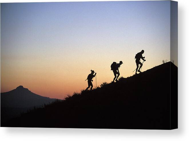 Adventure Racing Canvas Print featuring the photograph Two Men And One Woman Run Up A Mountain by Corey Rich