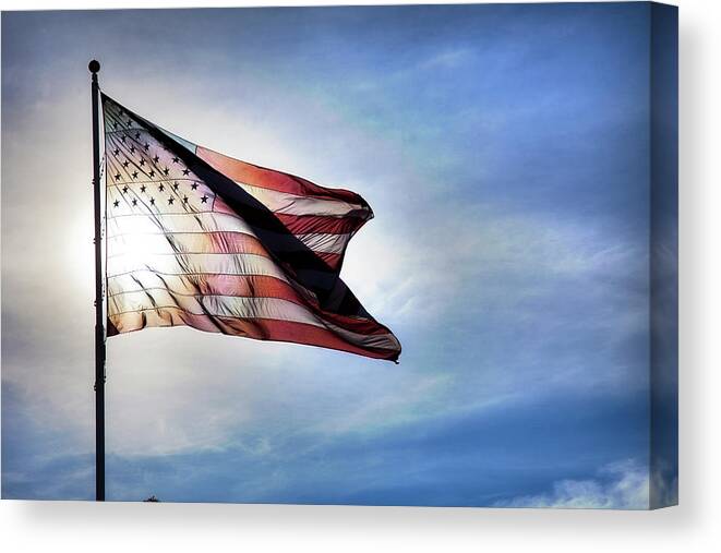 Curve Canvas Print featuring the photograph Us Flag Fluttering In Backlit Blue Sky by Strickke