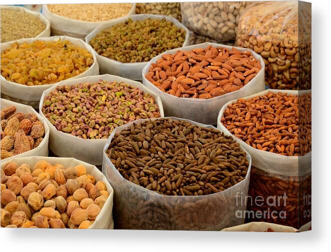 Nuts Canvas Print featuring the photograph Variety of raw nuts for sale at outdoor street market Karachi Pakistan by Imran Ahmed